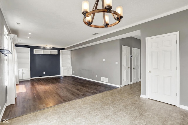 12322 Cool Winds Way W, Fishers, IN 46037 - unfurnished living room with a chandelier, built in features, wood finished floors, and ornamental molding