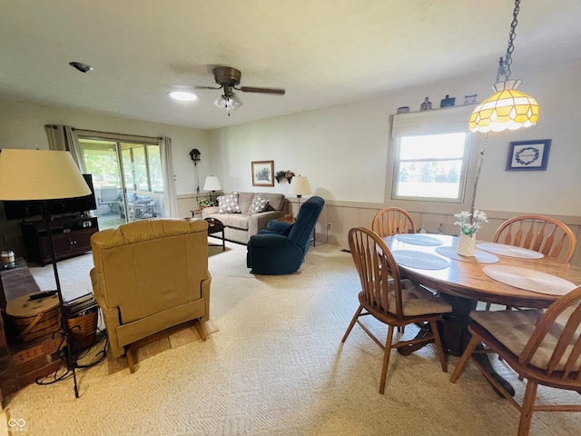 1008 Whispering Trl, Greenfield, IN 46140 - dining area with light carpet, wainscoting, and a ceiling fan