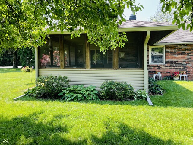 1008 Whispering Trl, Greenfield, IN 46140 - view of property exterior with a yard, brick siding, and roof with shingles