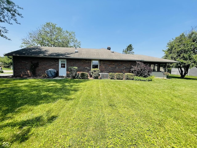 1008 Whispering Trl, Greenfield, IN 46140 - rear view of house featuring a yard and brick siding