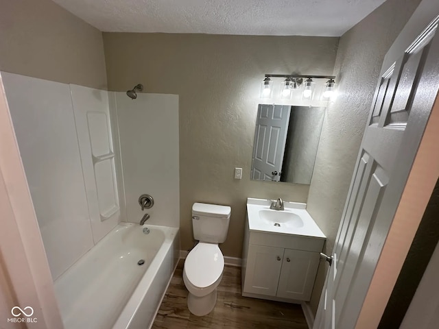 2951 S Elizabeth St, Indianapolis, IN 46203 - full bath featuring a textured wall, wood finished floors, vanity, tub / shower combination, and a textured ceiling