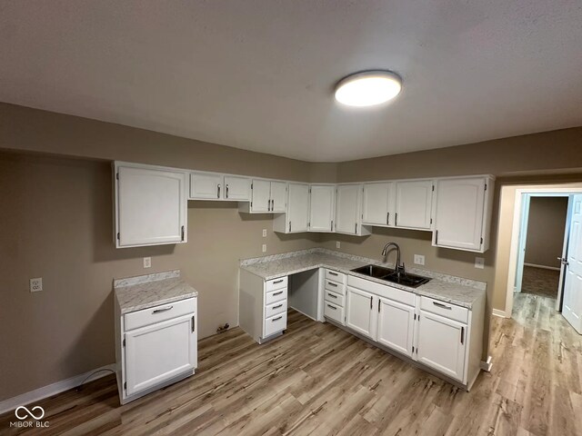 2951 S Elizabeth St, Indianapolis, IN 46203 - kitchen featuring light wood finished floors, white cabinets, and light countertops
