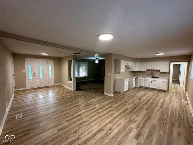 2951 S Elizabeth St, Indianapolis, IN 46203 - kitchen with open floor plan, wood finished floors, light countertops, white cabinetry, and a ceiling fan