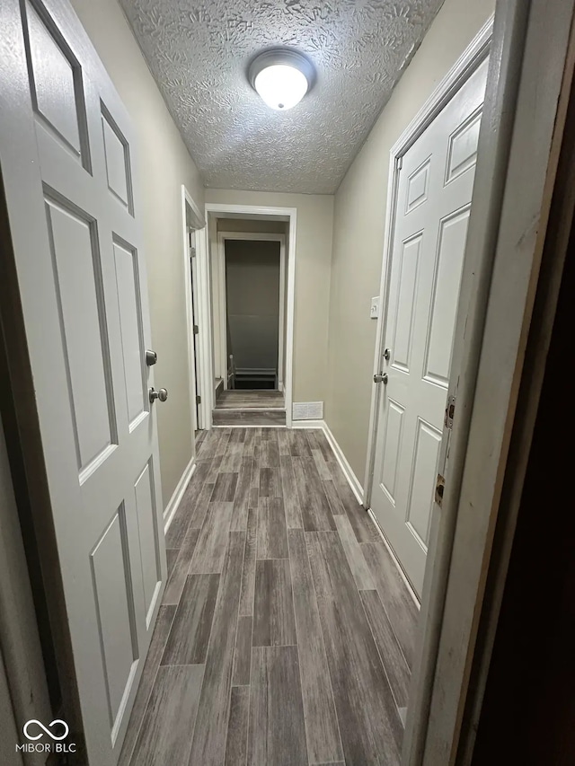 5704 N Keystone Ave, Indianapolis, IN 46220 - hallway featuring dark wood finished floors and a textured ceiling