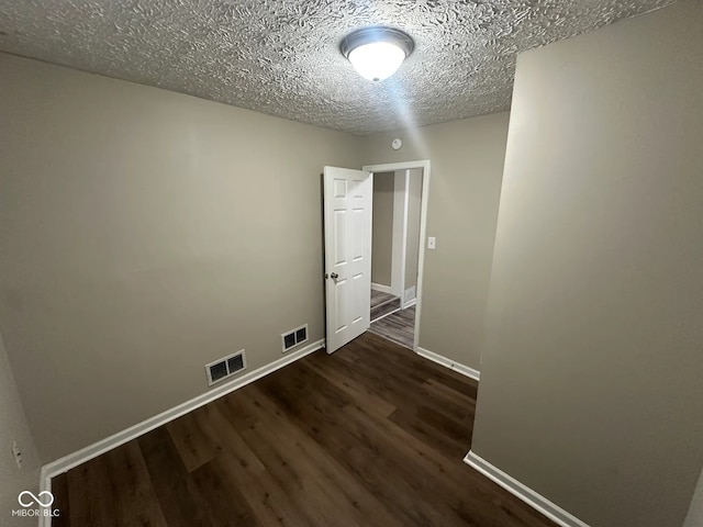 5704 N Keystone Ave, Indianapolis, IN 46220 - unfurnished room featuring dark wood-style floors and a textured ceiling