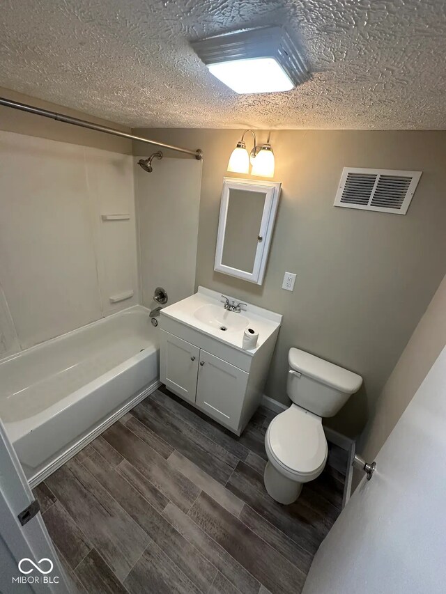 5704 N Keystone Ave, Indianapolis, IN 46220 - full bath featuring vanity, shower / bath combination, wood finished floors, and a textured ceiling