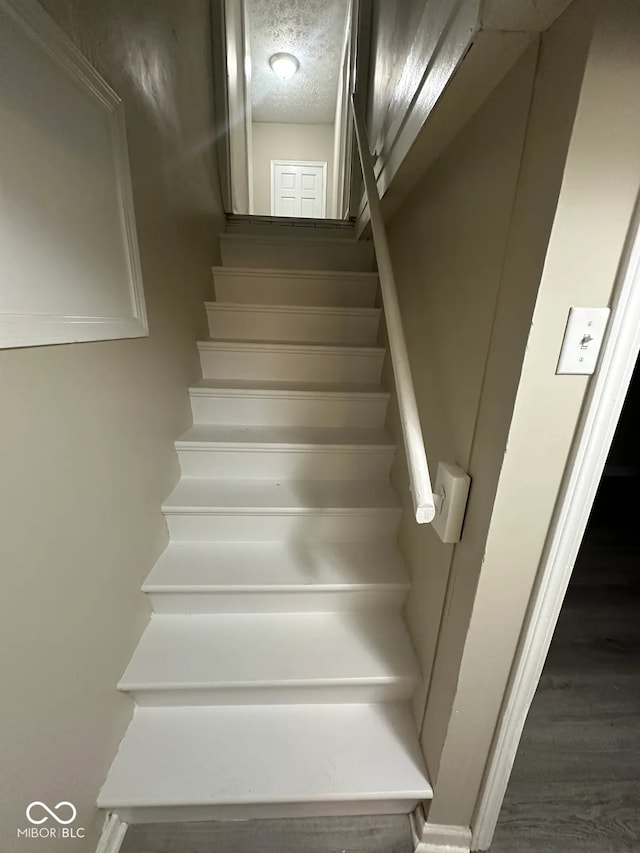 5704 N Keystone Ave, Indianapolis, IN 46220 - stairs with wood finished floors and a textured ceiling