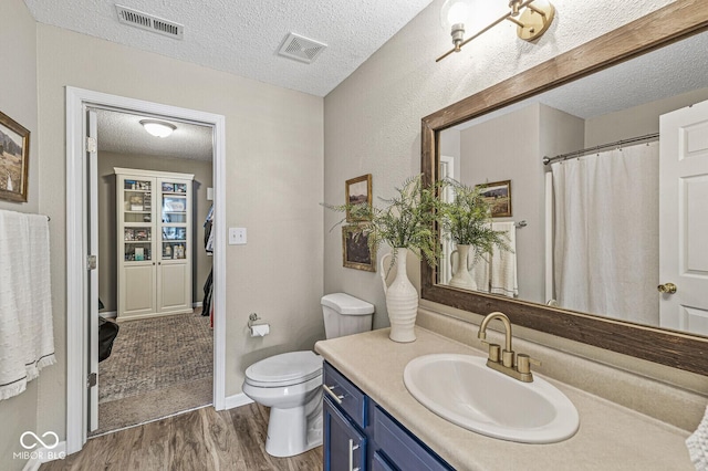 12259 Sweet Creek Trl, Fishers, IN 46037 - full bathroom featuring a textured ceiling, wood finished floors, and vanity