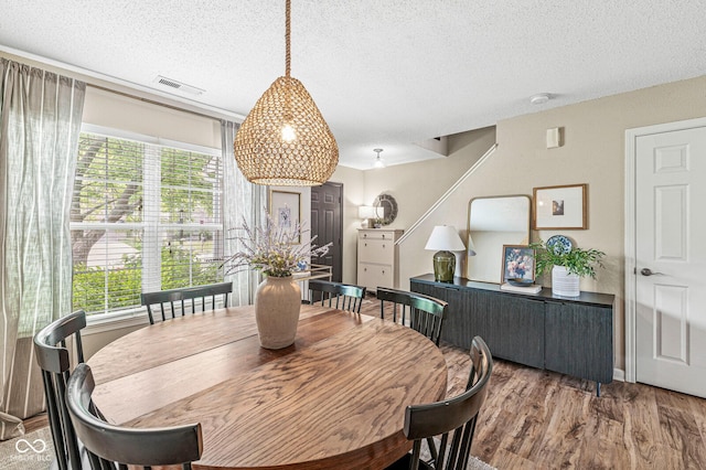 12259 Sweet Creek Trl, Fishers, IN 46037 - dining area featuring a textured ceiling, plenty of natural light, and wood finished floors