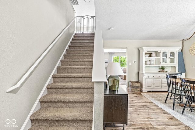 12259 Sweet Creek Trl, Fishers, IN 46037 - stairs featuring a textured ceiling and wood finished floors