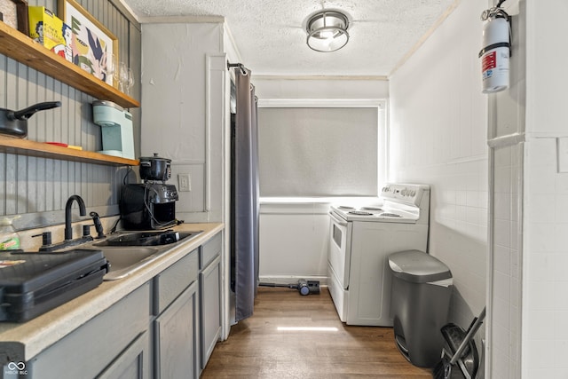 1849 E Minnesota St, Indianapolis, IN 46203 - washroom featuring washer and clothes dryer, wood finished floors, a textured ceiling, and wainscoting