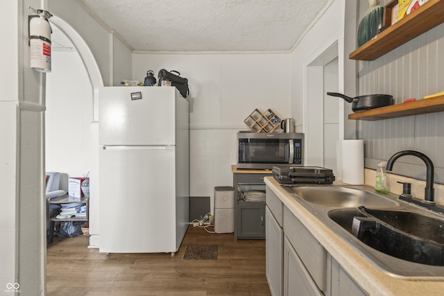 1849 E Minnesota St, Indianapolis, IN 46203 - kitchen with freestanding refrigerator, stainless steel microwave, open shelves, a textured ceiling, and dark wood-type flooring