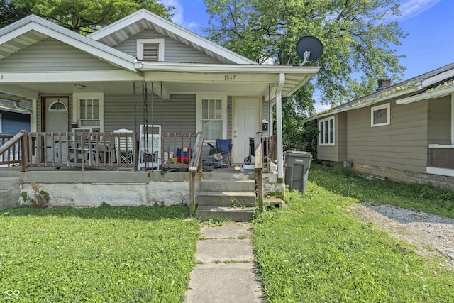 1849 E Minnesota St, Indianapolis, IN 46203 - view of front facade featuring covered porch and a front yard