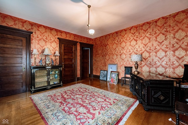 825 E Washington St, Muncie, IN 47305 - living room featuring wallpapered walls and wood finished floors