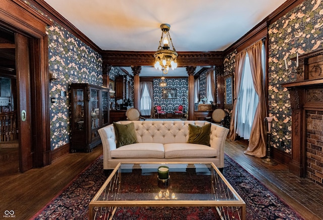 825 E Washington St, Muncie, IN 47305 - living room featuring hardwood / wood-style flooring, crown molding, wallpapered walls, and a chandelier