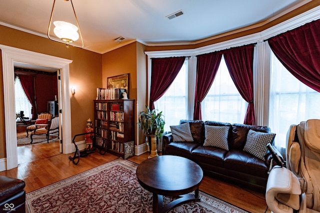 825 E Washington St, Muncie, IN 47305 - living area featuring wood finished floors and ornamental molding