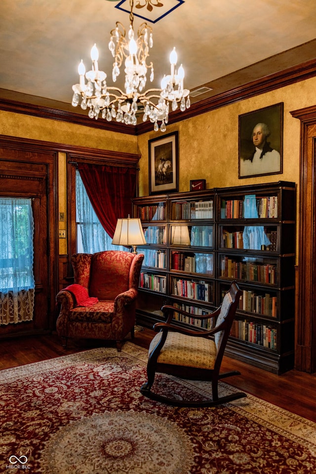 825 E Washington St, Muncie, IN 47305 - living area featuring wood finished floors, crown molding, and a chandelier