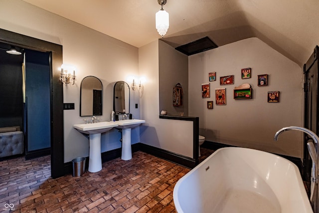 825 E Washington St, Muncie, IN 47305 - full bath with brick floors, a soaking tub, and lofted ceiling