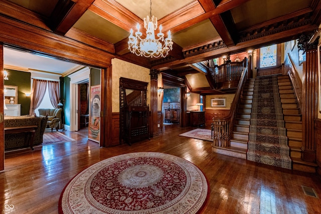 825 E Washington St, Muncie, IN 47305 - foyer with a chandelier, hardwood / wood-style floors, stairway, coffered ceiling, and beam ceiling