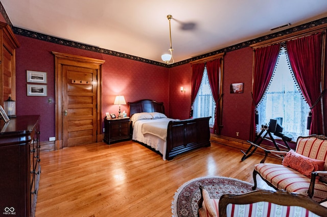 825 E Washington St, Muncie, IN 47305 - bedroom featuring light wood-style flooring and wallpapered walls