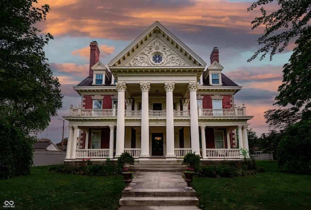 825 E Washington St, Muncie, IN 47305 - neoclassical / greek revival house with a balcony, covered porch, and a chimney