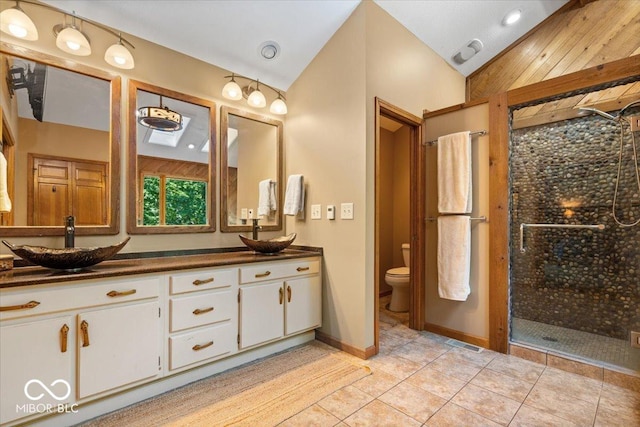 6975 Milhouse Rd, Indianapolis, IN 46221 - full bath with lofted ceiling, double vanity, a stall shower, and tile patterned flooring