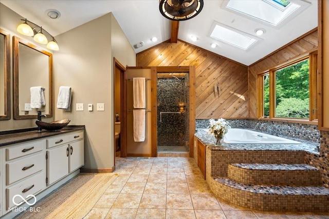 6975 Milhouse Rd, Indianapolis, IN 46221 - full bathroom with a skylight, vanity, wood walls, a garden tub, and a shower stall