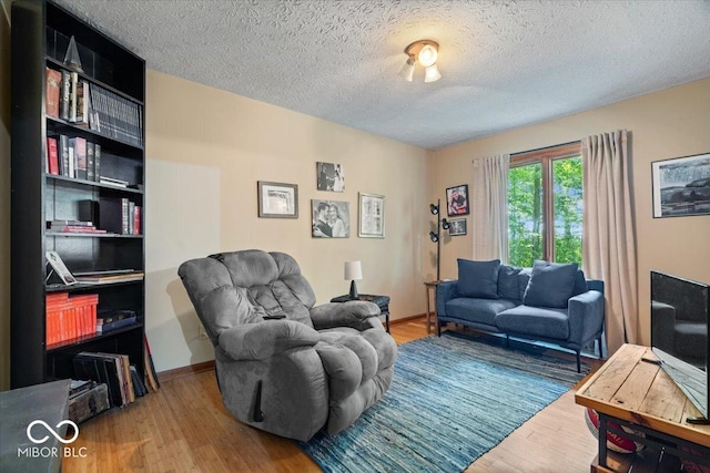 6975 Milhouse Rd, Indianapolis, IN 46221 - living area featuring wood finished floors and a textured ceiling