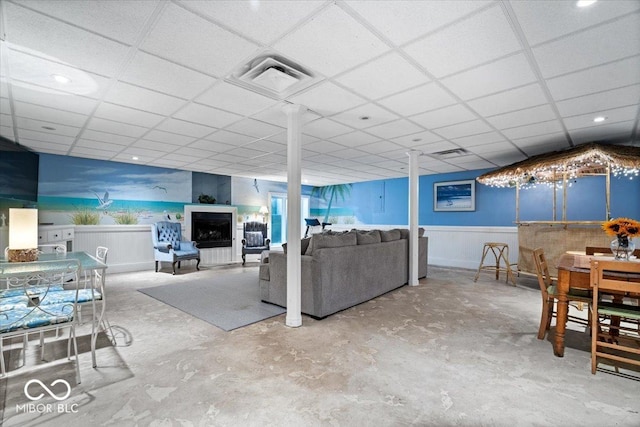6975 Milhouse Rd, Indianapolis, IN 46221 - living room featuring a paneled ceiling, wainscoting, and unfinished concrete floors