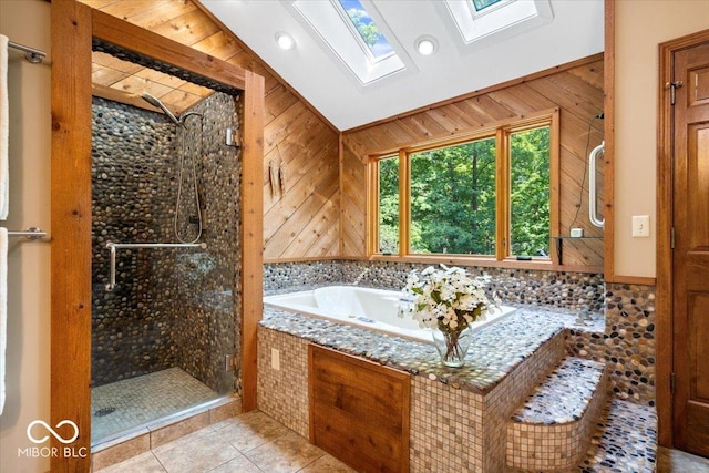 6975 Milhouse Rd, Indianapolis, IN 46221 - full bathroom with a skylight, vaulted ceiling, a stall shower, a bath, and wood walls