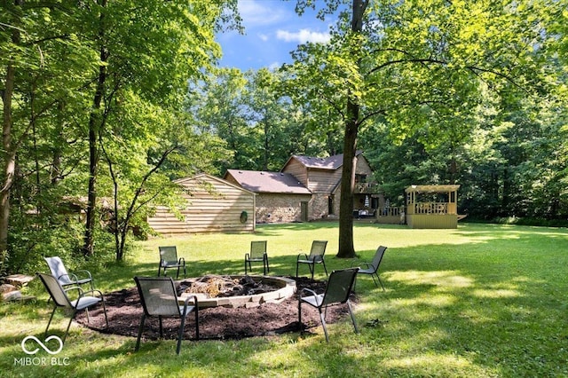 6975 Milhouse Rd, Indianapolis, IN 46221 - view of green lawn with an outdoor fire pit
