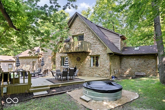 6975 Milhouse Rd, Indianapolis, IN 46221 - rear view of property featuring stone siding, a balcony, a yard, and a wooden deck