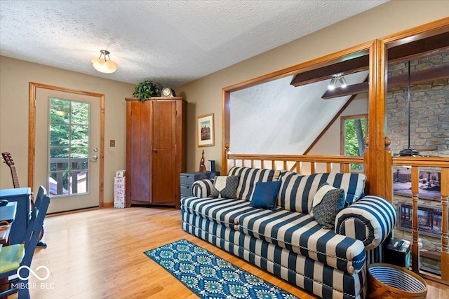 6975 Milhouse Rd, Indianapolis, IN 46221 - living area featuring wood finished floors, healthy amount of natural light, and a textured ceiling