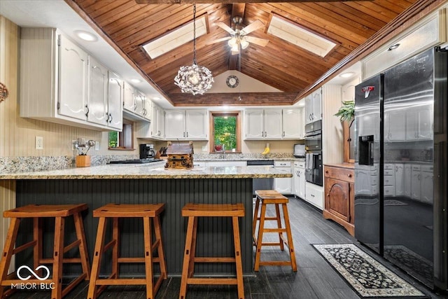 6975 Milhouse Rd, Indianapolis, IN 46221 - kitchen with a skylight, refrigerator with ice dispenser, wooden ceiling, a peninsula, and dark wood-type flooring