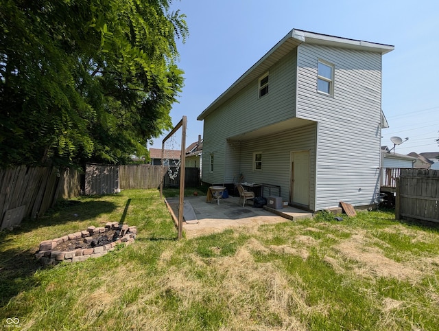 1609 Brown St, Anderson, IN 46016 - rear view of property with an outdoor fire pit, a fenced backyard, and a patio