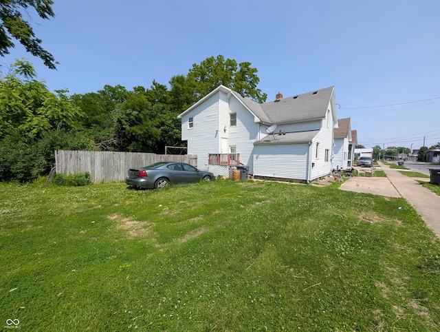 1609 Brown St, Anderson, IN 46016 - view of side of home featuring a chimney and a shingled roof