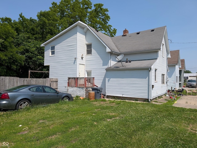 1609 Brown St, Anderson, IN 46016 - view of home's exterior with a shingled roof and a chimney