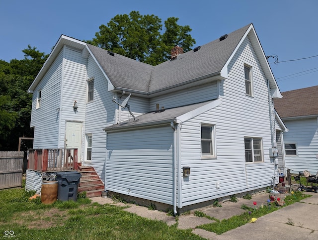 1609 Brown St, Anderson, IN 46016 - view of home's exterior featuring a chimney and a shingled roof