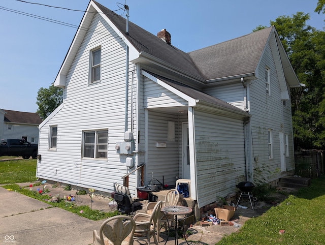 1609 Brown St, Anderson, IN 46016 - view of property exterior with a chimney and a shingled roof