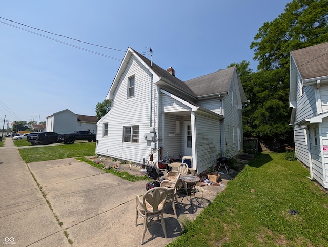 1609 Brown St, Anderson, IN 46016 - rear view of house with a chimney and a yard