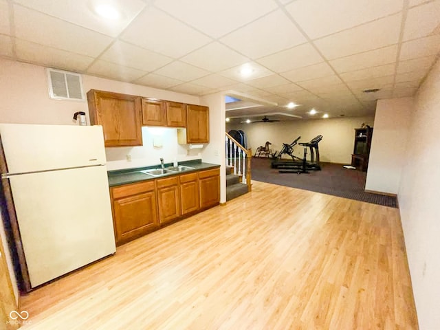 14266 S 125 E, Clinton, IN 47842 - kitchen with freestanding refrigerator, light wood finished floors, dark countertops, brown cabinetry, and a paneled ceiling