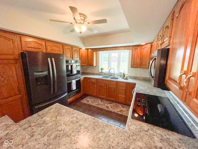 14266 S 125 E, Clinton, IN 47842 - kitchen featuring appliances with stainless steel finishes, a ceiling fan, brown cabinetry, and light stone counters