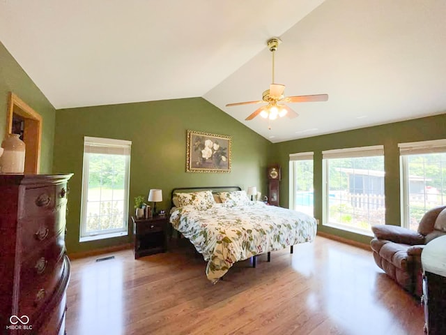 14266 S 125 E, Clinton, IN 47842 - bedroom with wood finished floors, lofted ceiling, multiple windows, and ceiling fan
