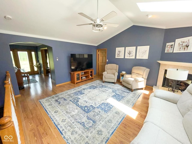 14266 S 125 E, Clinton, IN 47842 - living area featuring arched walkways, ceiling fan, wood finished floors, lofted ceiling, and a skylight