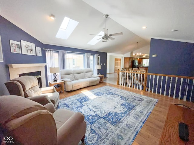 14266 S 125 E, Clinton, IN 47842 - living area featuring vaulted ceiling, light wood-style flooring, a ceiling fan, plenty of natural light, and a fireplace