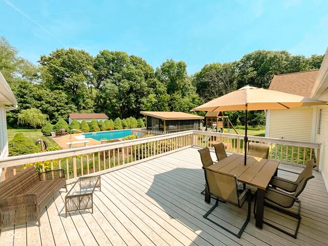14266 S 125 E, Clinton, IN 47842 - deck featuring a playground, outdoor dining space, and an outdoor pool