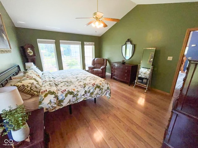 14266 S 125 E, Clinton, IN 47842 - bedroom featuring wood finished floors, vaulted ceiling, and ceiling fan