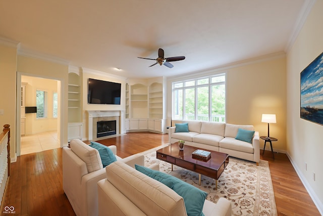 8069 Middle Bay Ln, Indianapolis, IN 46236 - living room featuring ornamental molding, a ceiling fan, hardwood / wood-style floors, built in features, and plenty of natural light