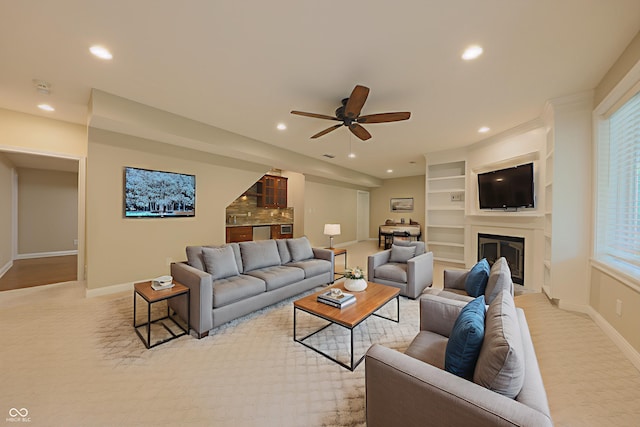 8069 Middle Bay Ln, Indianapolis, IN 46236 - living room with light colored carpet, a ceiling fan, recessed lighting, plenty of natural light, and a glass covered fireplace