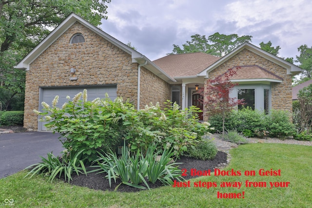 8069 Middle Bay Ln, Indianapolis, IN 46236 - view of front of property with stone siding, asphalt driveway, roof with shingles, and a garage